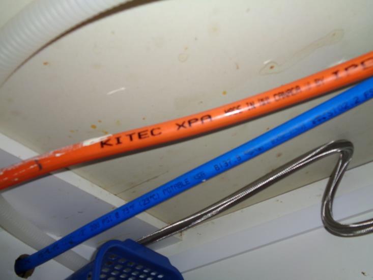 Orange and blue kitec piping installed at kitchen sink