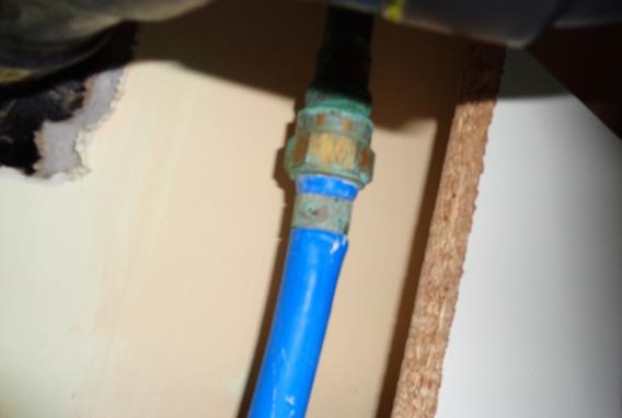 Example of blue Kitec piping bulging below fitting taken at a home inspection