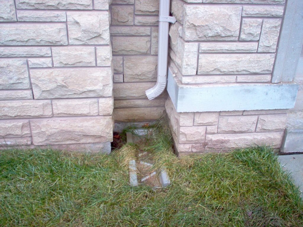 Example photo of downspouts that need to be extended