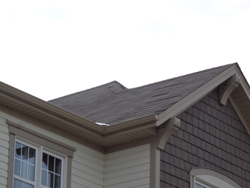 3 or 4 missing shingles from a roof.