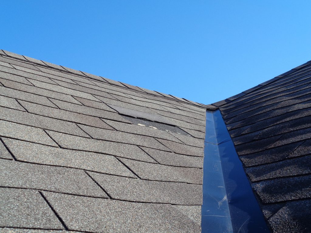 A roof with one missing shingle